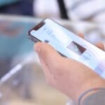 a person holding a smart phone in their hand