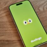 A green phone with a face drawn on it