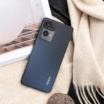 a cell phone sitting on top of a table next to a book