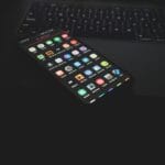 black iphone 5 on black computer keyboard