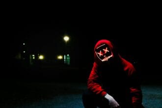 man squatting during nighttime