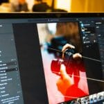 Photo editing software is shown on a laptop screen.