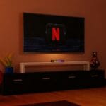 a living room with a flat screen tv on the wall