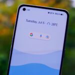 a close up of a person holding a cell phone