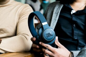 a person holding a pair of headphones in their hands