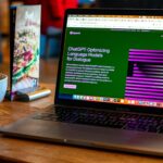 a laptop computer sitting on top of a wooden table