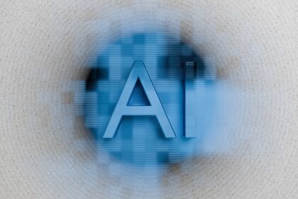 The letters ai are displayed on a blurred background.