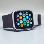 A smartwatch with a dark textured band and a colorful app icon display
