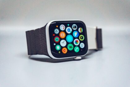 A smartwatch with a dark textured band and a colorful app icon display